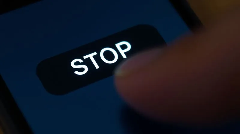 A photorealistic close-up of a finger tapping 'STOP' on a smartphone text message, with a subtle glow around the text, representing a clear and effective opt-out mechanism. Professional photography, 8K, cinematic lighting, sharp focus, depth of field, shot on a high-end DSLR.