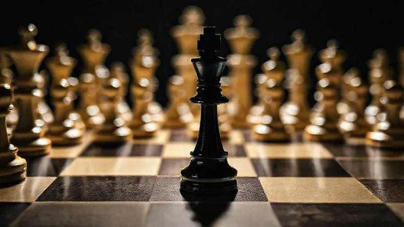 Photorealistic, professional photography, 8K, cinematic lighting, sharp focus, depth of field, shot on a high-end DSLR. A close-up of a chessboard, with a single black pawn isolated but strategically positioned against a multitude of white pieces. The lighting is dramatic, casting long shadows, highlighting the tension and strategic challenge. The focus is sharp on the pawn, with the background pieces slightly blurred, symbolizing a complex legal defense strategy against overwhelming odds.